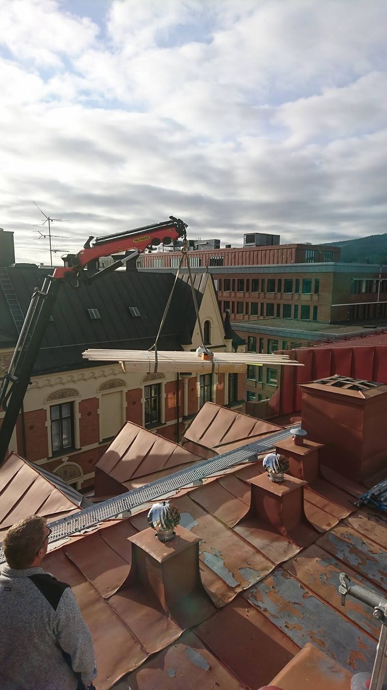 Plåtarbete på ett kopparplåttak i stadsmiljö